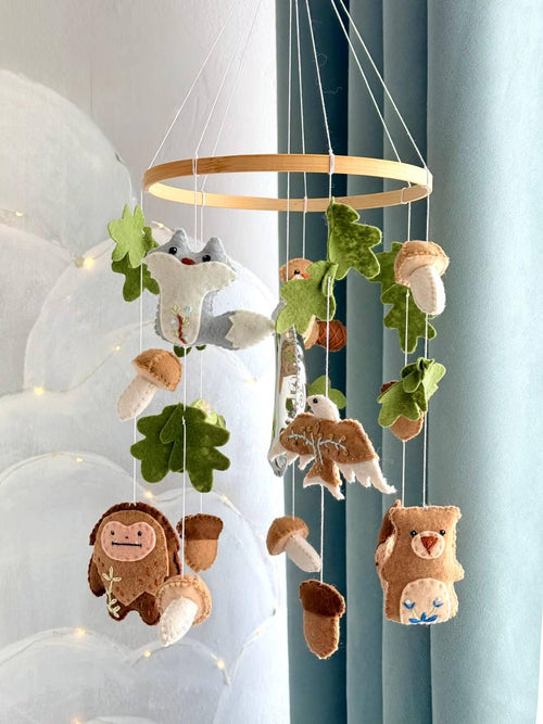 Handmade felt Seven Teachings Forest Mobile hanging from a wooden hoop