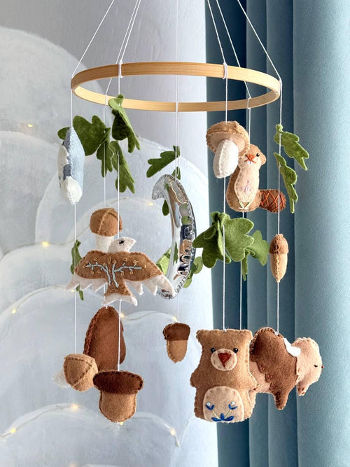 Handmade felt Seven Teachings Forest Mobile hanging from a wooden hoop