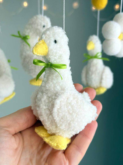 Handmade felt Fluffy Goose Baby Mobile hanging from a wooden hoop