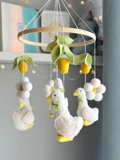 Handmade felt Fluffy Goose Baby Mobile hanging from a wooden hoop